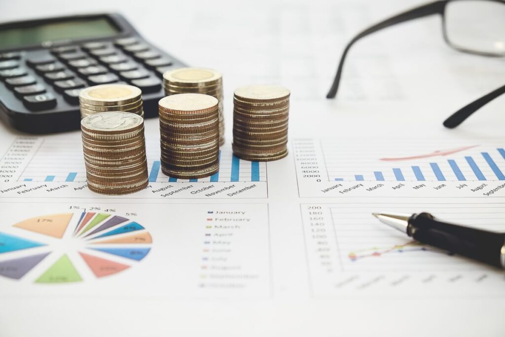 accounting report papers with calculator and coins sitting on top